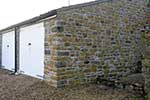 Garage extension to a grade II listed property in a conservation area. Built in White Lias and Doulting stone, use of reclaimed materials and natural stone Copings.