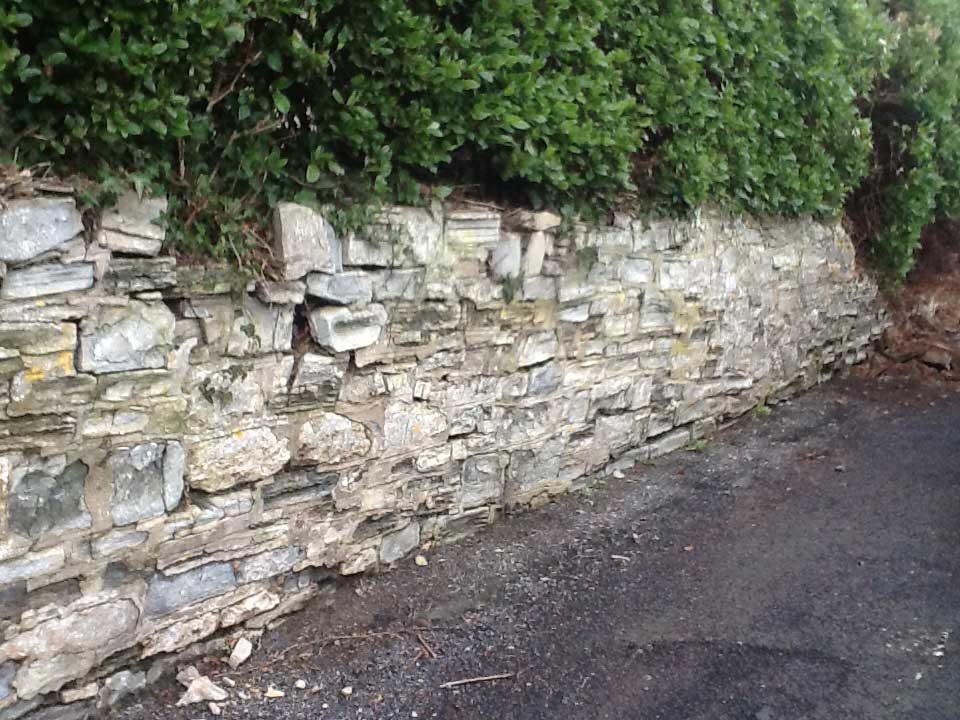 Grade II listed wall partially taken down.